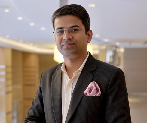 Friendly Indian Businesswoman Wearing a Suit in City Setting