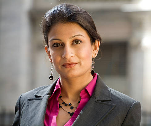 Friendly Indian Businesswoman Wearing a Suit in City Setting